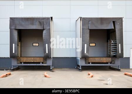 Loading dock or loading bay with bumpers, levelers, lift, dock seals or shelters, traffic lights. Loading bay is area of building where goods vehicles Stock Photo