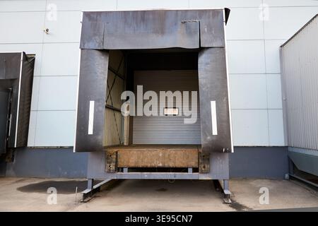 Loading dock or loading bay with bumpers, levelers, lift, dock seals or shelters, traffic lights. Loading bay is area of building where goods vehicles Stock Photo