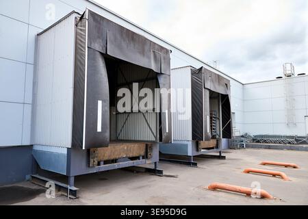 Loading dock or loading bay with bumpers, levelers, lift, dock seals or shelters, traffic lights. Loading bay is area of building where goods vehicles Stock Photo