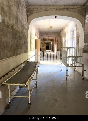 old abandoned Hospital corridor with sick bed in a lost place sanatorium vertical Stock Photo