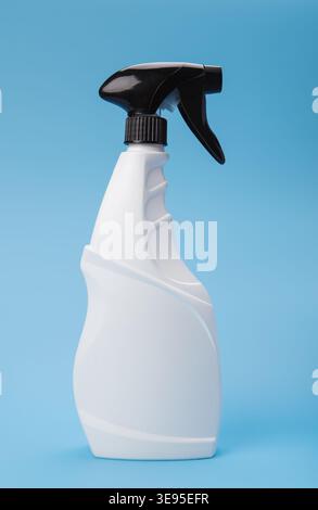 White Trigger Spray Bottle on Blue Background Stock Photo