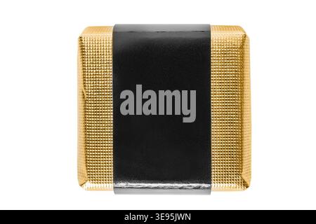 Candy wrapped in golden foil isolated on white background Stock Photo