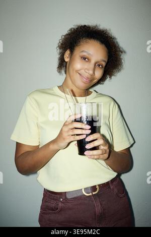 Portrait of Black Woman Holding Soft Drink for Casual Lifestyle Ad Stock Photo