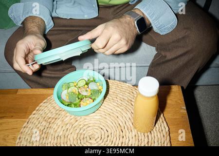 Adult Man Preparing Healthy Salad Meal for Home Lunch Routine Stock Photo