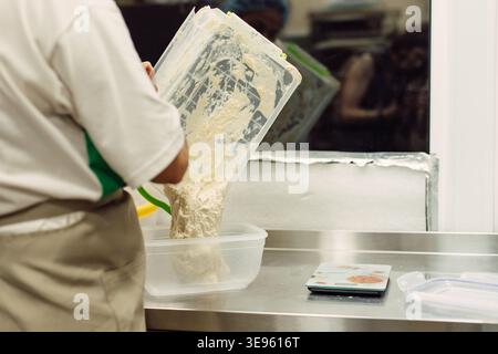 close up of fermented dough in bowl bubble white flour ferment fermentation yeast leavened bread baking biga poolish bakery Stock Photo