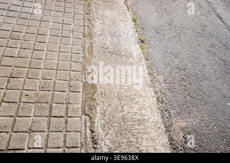 Grey urban textures of a sidewalk and road The Concept of city environmentAsphalt road and sidewalk with a concrete curb The Concept of urban infrastr Stock Photo