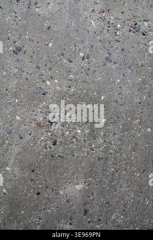 Texture of rough concrete wall with visible stones. Close up of gray concrete wall for template and background. Stock Photo