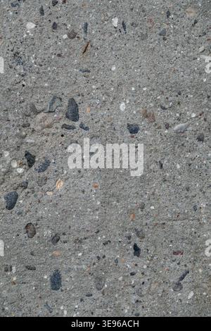Texture of rough concrete wall with visible stones. Close up of gray concrete wall for template and background. Stock Photo