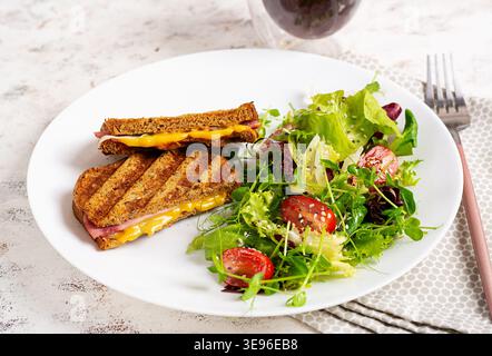 Balanced meal with grilled sandwich and salad, clean eating concept Stock Photo