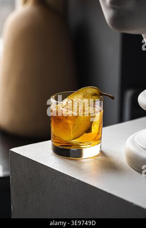 Whiskey cocktail with pear garnish in glass Stock Photo