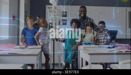 Examining teacher wearing plaid and five pupils gathering around skeleton in school, with notes Stock Photo
