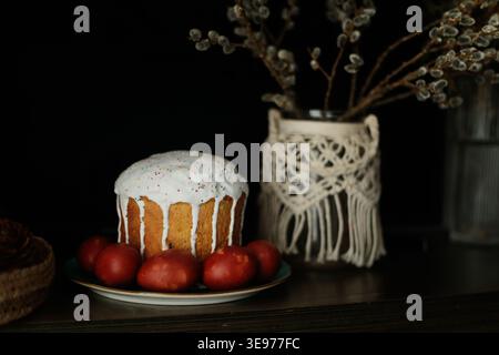 Traditional Easter cake with icing and red eggs Stock Photo