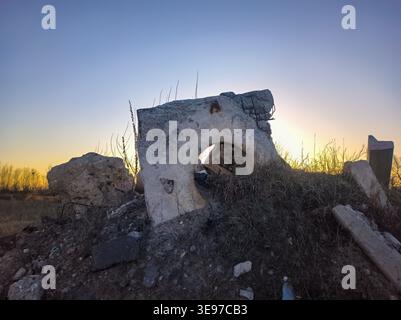 Silent Decayed Landscape. Desolate Building Remains Bathed In Soft Evening Light Symbolizing Neglect Stock Photo