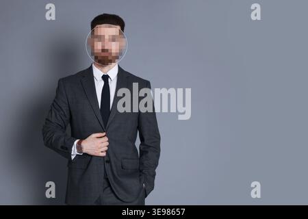 Anonymous man with pixelated face on grey background Stock Photo