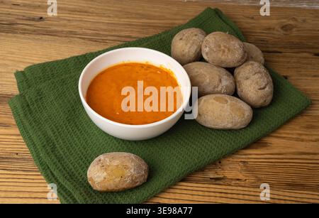 Red mojo rojo and green mojo verde sauces, traditional Tenerife dips, mojo picon dressing, Canary Islands Papas arrugadas sea water boiled potatoes, S Stock Photo