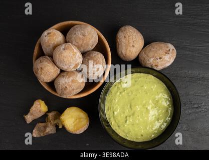 Red mojo rojo and green mojo verde sauces, traditional Tenerife dips, mojo picon dressing, Canary Islands Papas arrugadas sea water boiled potatoes, S Stock Photo