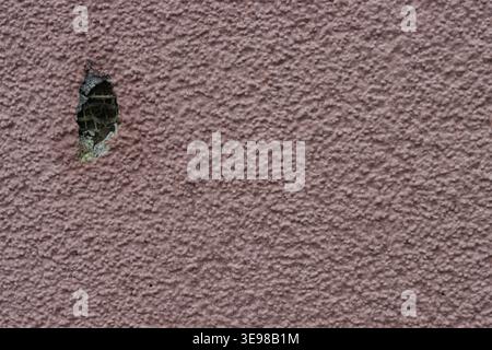 Peeling paint reveals dark underlayer beneath. Slight color shift suggests weathering or age. Ideal for themes of decay, damage, or hidden exposure Stock Photo