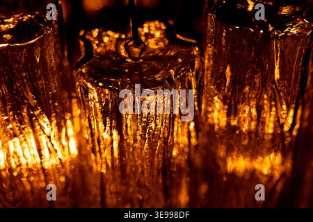 Abstract golden light through textured glass surface Stock Photo