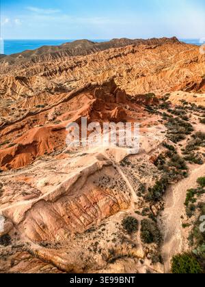aerial-view-of-issyk-kul-lake-at-sunset-with-rugged-canyon-terrain-in
