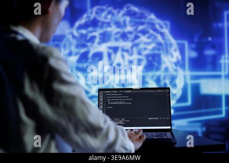 Admin writes code on laptop to visualize artificial intelligence neural networks made up of interconnected nodes using augmented reality technology. Expert running AI script for data processing Stock Photo