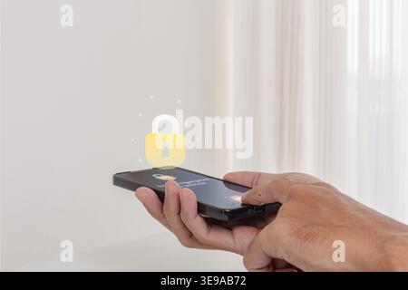 A man unlocking his smartphone by scanning his fingerprint on the screen. Security access with biometric identification concept. Stock Photo