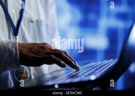 Trained developer writes code on laptop to visualize artificial intelligence neural networks using augmented reality, close up. Server farm specialist runs AI script for information processing Stock Photo