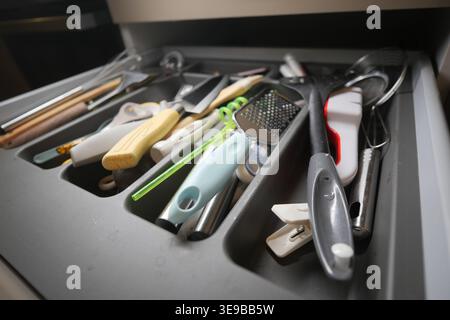 Kitchen utensils in a drawer during daytime Stock Photo