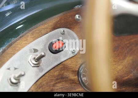 Close view of buttons and gauge in a old vehicle cockpit Stock Photo