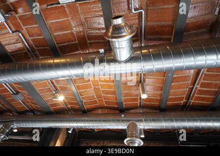 View of pipes on ceiling in a restaurant setting Stock Photo