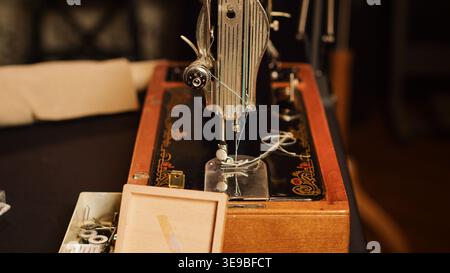 Tools on workstation in fashion atelier, needles and threads used for sewing and manufacturing clothes. Tailor workshop filled with textile industry equipment, craftsmanship. Close up. Stock Photo