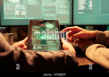 Thieves team successfully hacking government server and stealing passwords for ransom, phishing concept at night. Young people using online malware to access important database system. Stock Photo