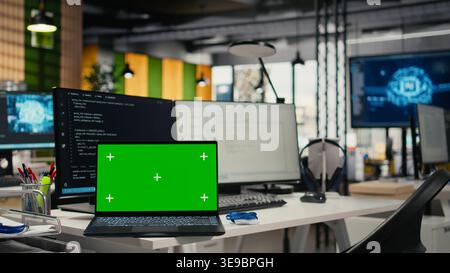 Isolated screen laptop on office desk used to implement algorithms enabling machine learning. Artificial intelligence technology company workspace with mockup notebook used to conduct code reviews Stock Photo
