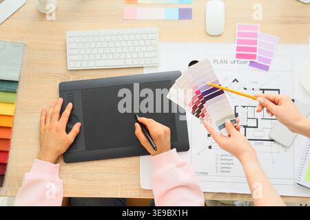 Hands of interior designers working on table, top view Stock Photo