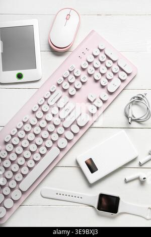 Composition with different modern gadgets on white wooden background Stock Photo