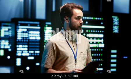 Engineer doing maintenance in server room providing secure, scalable, and reliable infrastructure for storing, processing, and analyzing large amounts of data generated by AI applications Stock Photo