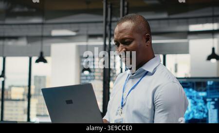 Engineers in office doing software development to launch new features. Startup company IT workers writing computer programs, doing code testing and quality assurance, camera B Stock Photo