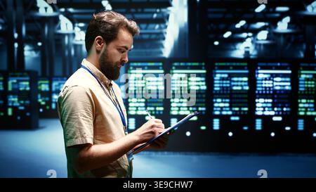 Experienced system administrator maintenancing interlinked computers creating server network. Data storage service business using parallel computing to perform complex calculations Stock Photo