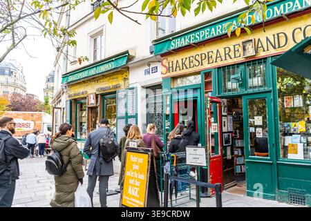 Paris, France - October 30, 2025: Shakespeare and company old city lights books shop. People in line stand on street to go to old bookstore Stock Photo