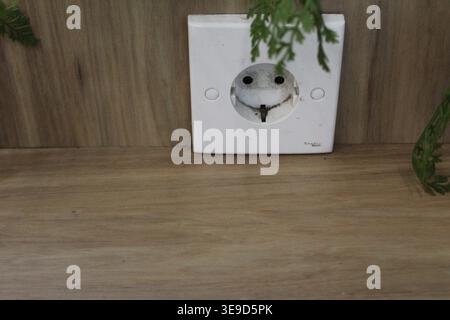 Dirty Power Outlet on a Wooden Table at a Minimarket Stock Photo
