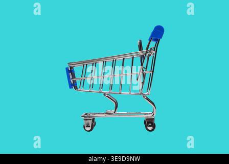 Shopping cart on blue background Stock Photo