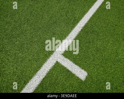 a soccer arena on the green grass on the line on corner in soccer stadium. Stock Photo