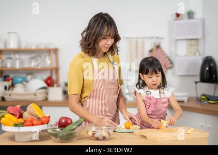 activities together during the holidays. mother and daughter are having a meal together, Mother prepare breakfast for daughter on morning, enjoy, week Stock Photo