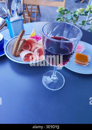 Communion Lunch Dark red beverage with sliced bread, white flowers, and a closed ...