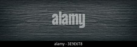 Old cracked black painted solid wooden surface wide texture. Dark gray wood panoramic retro background Stock Photo