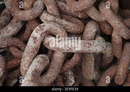 Old, rusty chains close up in an image. Stock Photo