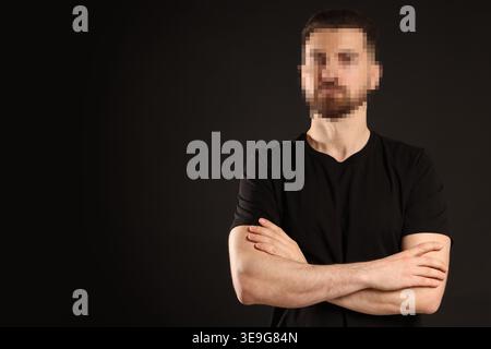 Anonymous man with pixelated face on black background Stock Photo