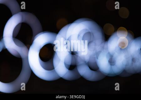Defocused glowing rings of light in the night Stock Photo