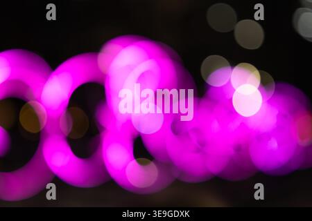 Abstract pink bokeh lights on dark background Stock Photo