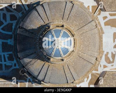 Upward view of the stone dome interior with circular skylight at the Church of St Nicholas in Siggiewi, Malta, showing radial masonry segments and nat Stock Photo