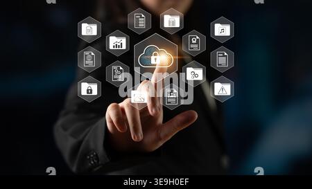 A businessperson interacts with cloud technology, showcasing data security icons. This image embodies modern connectivity and innovation in the tech Stock Photo